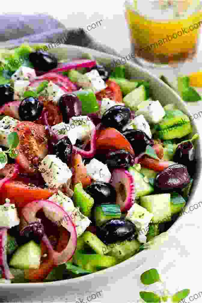 A Bowl Of Greek Salad Featuring Fresh Tomatoes, Cucumbers, Onions, And Feta Cheese, Tossed In An Olive Oil And Lemon Juice Dressing The Easy Puerto Rican Cookbook: 100 Classic Recipes Made Simple
